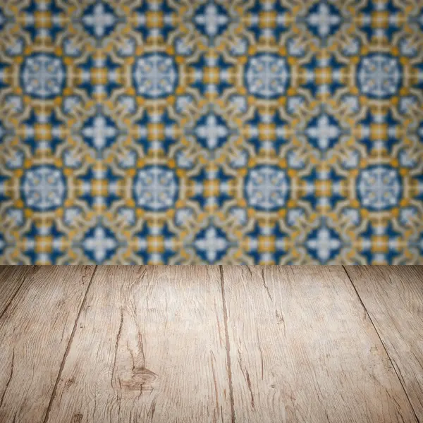 Wood table top and blur vintage ceramic tile pattern wall — Stock Photo, Image