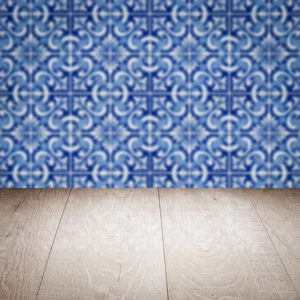 Wood table top and blur vintage ceramic tile pattern wall — Stock Photo, Image