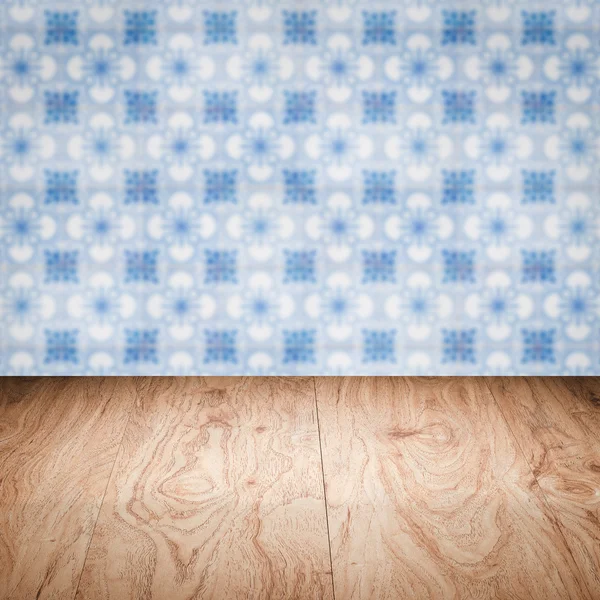 Wood table top and blur vintage ceramic tile pattern wall — Stock Photo, Image