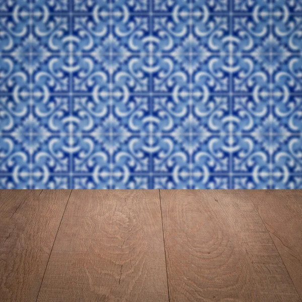 Wood table top and blur vintage ceramic tile pattern wall — Stock Photo, Image