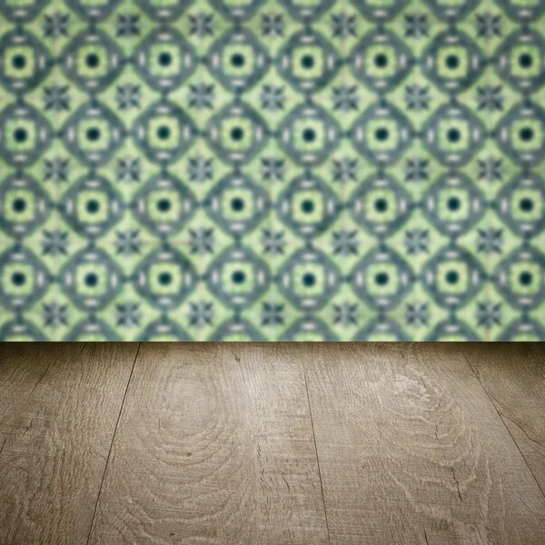 Wood table top and blur vintage ceramic tile pattern wall — Stock Photo, Image