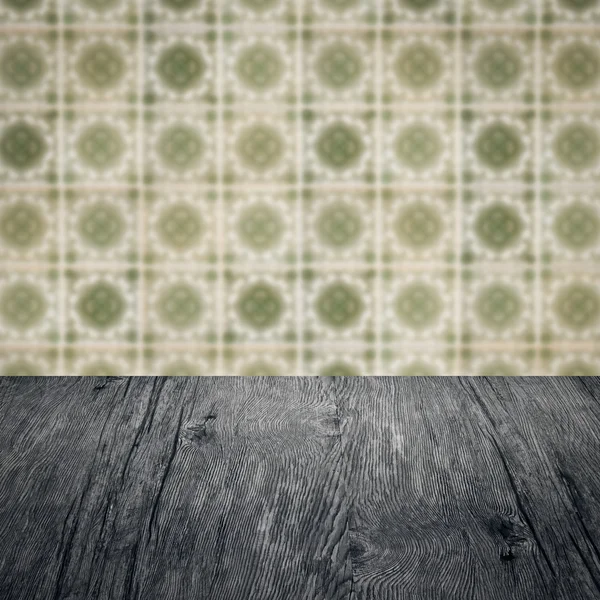 Wood table top and blur vintage ceramic tile pattern wall — Stock Photo, Image