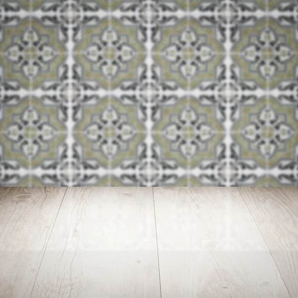 Wood table top and blur vintage ceramic tile pattern wall — Stock Photo, Image