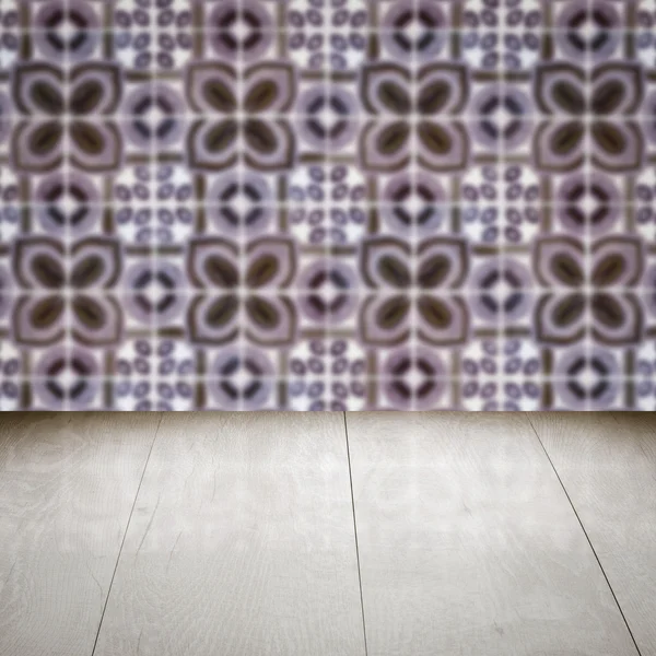 Wood table top and blur vintage ceramic tile pattern wall — Stock Photo, Image