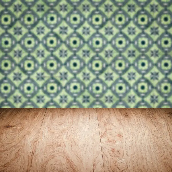 Wood table top and blur vintage ceramic tile pattern wall — Stock Photo, Image