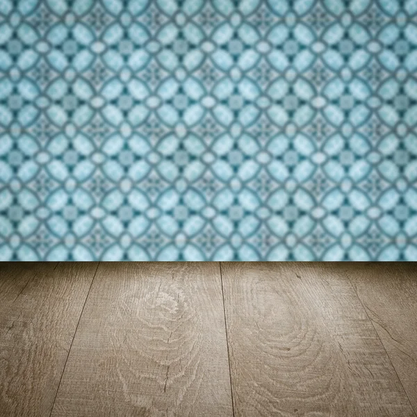 Wood table top and blur vintage ceramic tile pattern wall — Stock Photo, Image