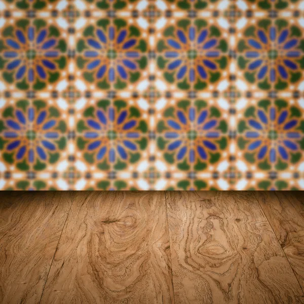 Wood table top and blur vintage ceramic tile pattern wall — Stock Photo, Image