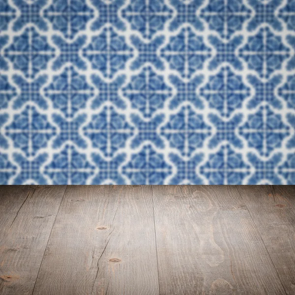 Wood table top and blur vintage ceramic tile pattern wall — Stock Photo, Image