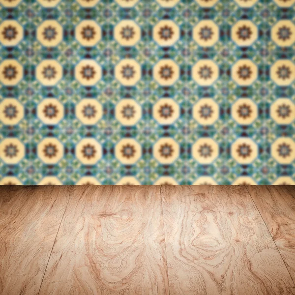 Wood table top and blur vintage ceramic tile pattern wall — Stock Photo, Image