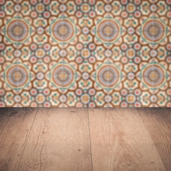 Wood table top and blur vintage ceramic tile pattern wall — Stock Photo, Image