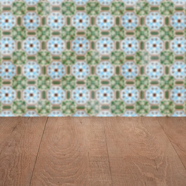 Wood table top and blur vintage ceramic tile pattern wall — Stock Photo, Image