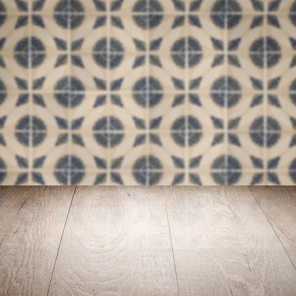 Wood table top and blur vintage ceramic tile pattern wall — Stock Photo, Image