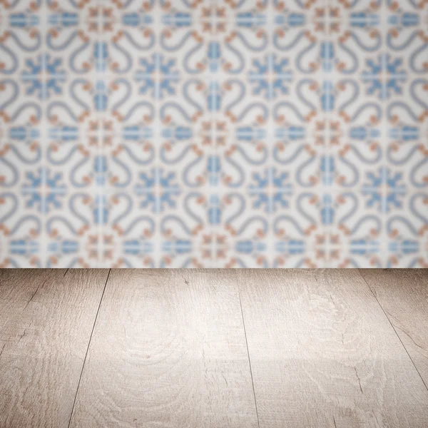 Wood table top and blur vintage ceramic tile pattern wall — Stock Photo, Image