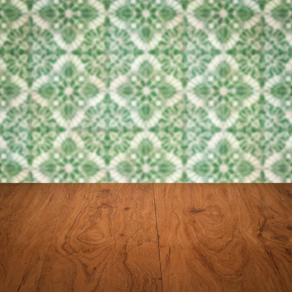 Wood table top and blur vintage ceramic tile pattern wall — Stock Photo, Image