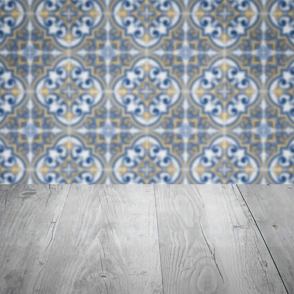 Wood table top and blur vintage ceramic tile pattern wall — Stock Photo, Image