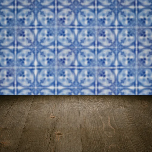 Wood table top and blur vintage ceramic tile pattern wall — Stock Photo, Image