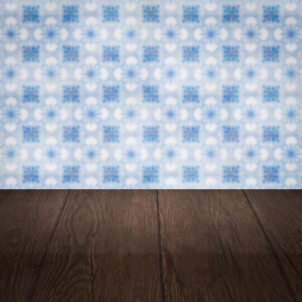 Wood table top and blur vintage ceramic tile pattern wall — Stock Photo, Image