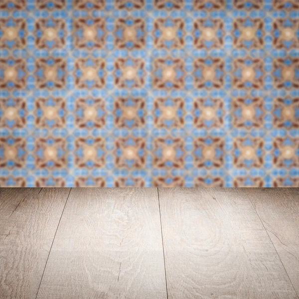 Wood table top and blur vintage ceramic tile pattern wall — Stock Photo, Image