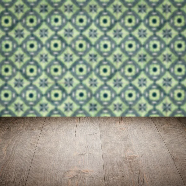 Wood table top and blur vintage ceramic tile pattern wall — Stock Photo, Image