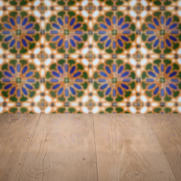 Wood table top and blur vintage ceramic tile pattern wall — Stock Photo, Image