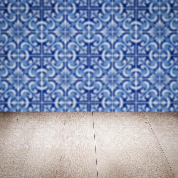 Wood table top and blur vintage ceramic tile pattern wall — Stock Photo, Image