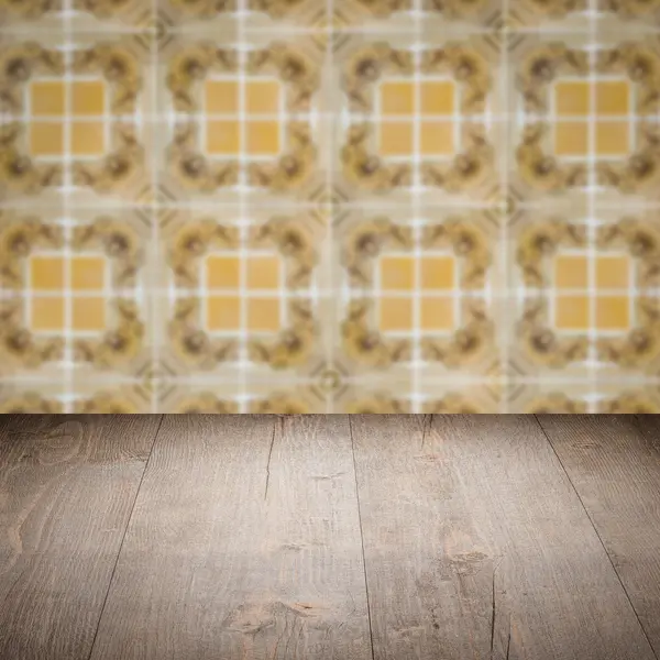 Wood table top and blur vintage ceramic tile pattern wall — Stock Photo, Image