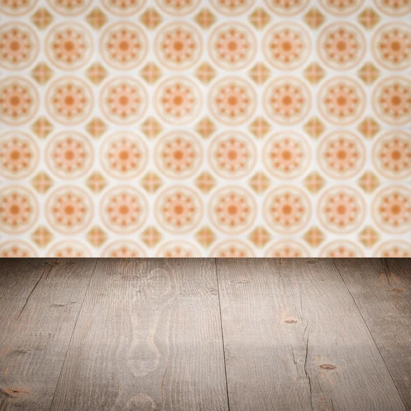 Wood table top and blur vintage ceramic tile pattern wall — Stock Photo, Image