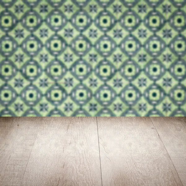 Wood table top and blur vintage ceramic tile pattern wall — Stock Photo, Image