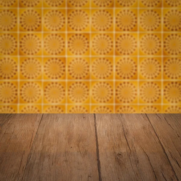 Wood table top and blur vintage ceramic tile pattern wall — Stock Photo, Image