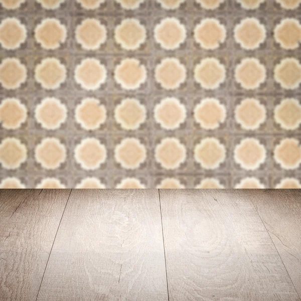 Wood table top and blur vintage ceramic tile pattern wall — Stock Photo, Image