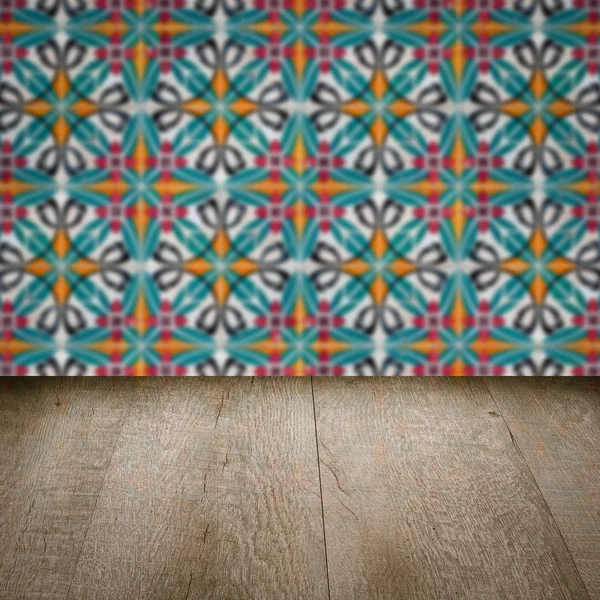 Wood table top and blur vintage ceramic tile pattern wall — Stock Photo, Image