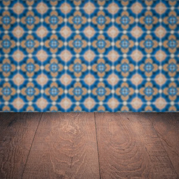 Wood table top and blur vintage ceramic tile pattern wall — Stock Photo, Image