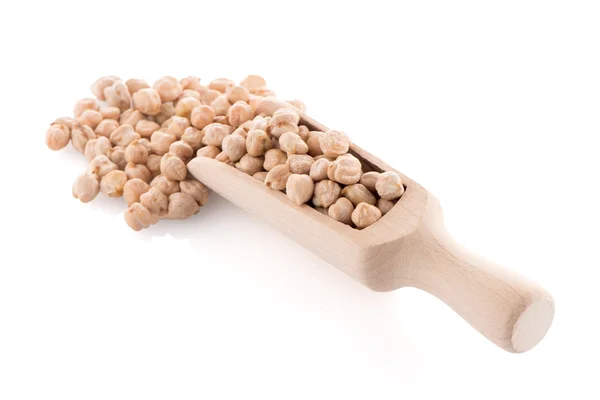 Uncooked chickpeas and wooden scoop — Stock Photo, Image
