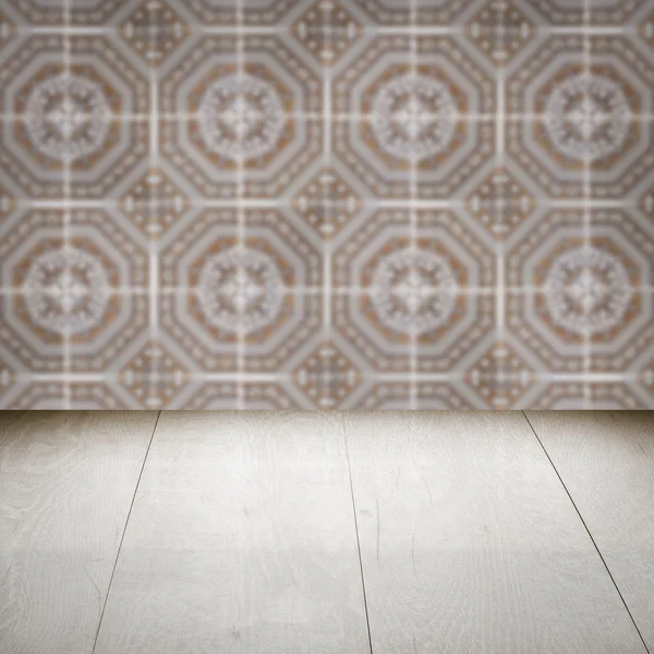 Wood table top and blur vintage ceramic tile pattern wall — Stock Photo, Image