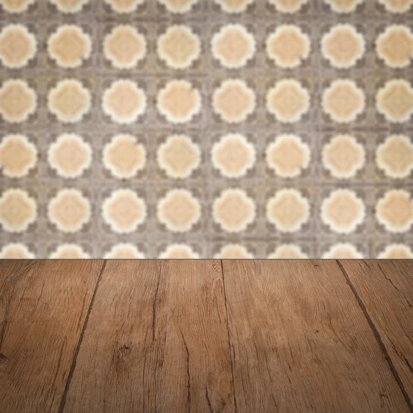 Wood table top and blur vintage ceramic tile pattern wall — Stock Photo, Image