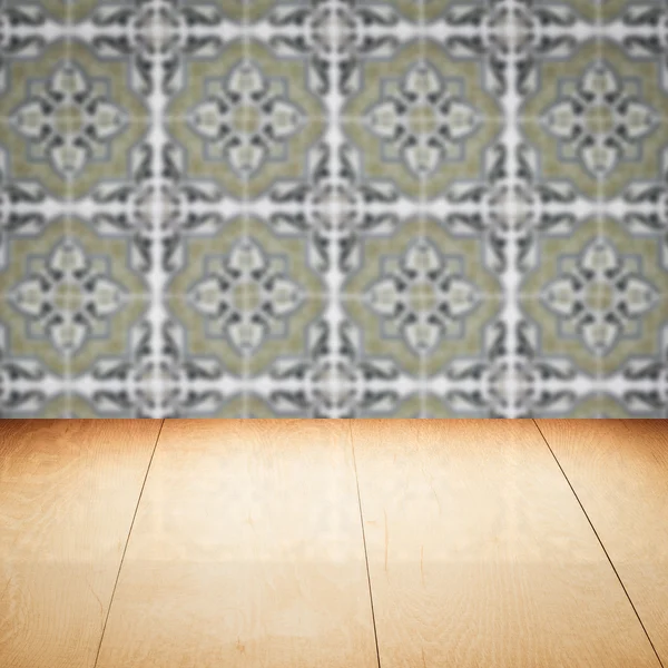 Wood table top and blur vintage ceramic tile pattern wall — Stock Photo, Image