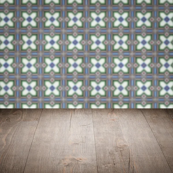 Wood table top and blur vintage ceramic tile pattern wall — Stock Photo, Image