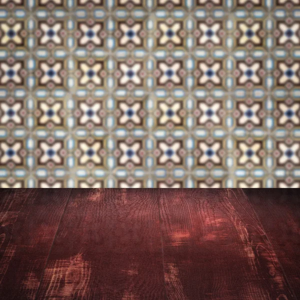 Wood table top and blur vintage ceramic tile pattern wall — Stock Photo, Image