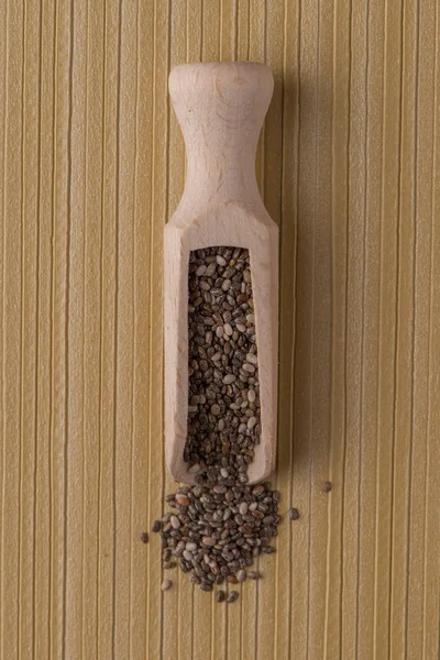 Wooden scoop with chia seeds — Stock Photo, Image