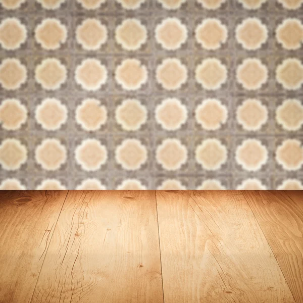 Wood table top and blur vintage ceramic tile pattern wall — Stock Photo, Image