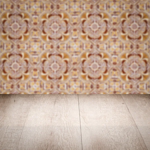 Wood table top and blur vintage ceramic tile pattern wall — Stock Photo, Image