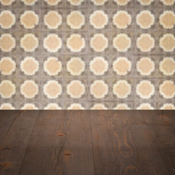 Wood table top and blur vintage ceramic tile pattern wall — Stock Photo, Image