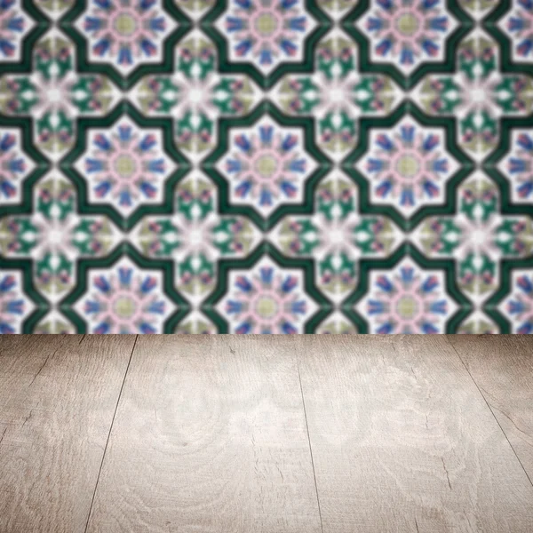 Wood table top and blur vintage ceramic tile pattern wall — Stock Photo, Image