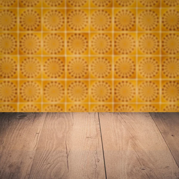 Wood table top and blur vintage ceramic tile pattern wall — Stock Photo, Image