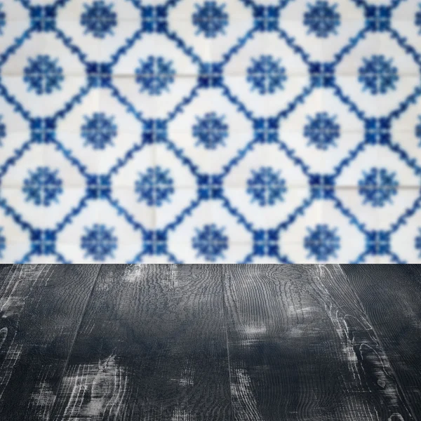 Wood table top and blur vintage ceramic tile pattern wall — Stock Photo, Image