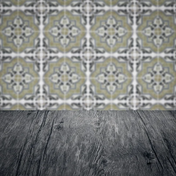 Wood table top and blur vintage ceramic tile pattern wall — Stock Photo, Image