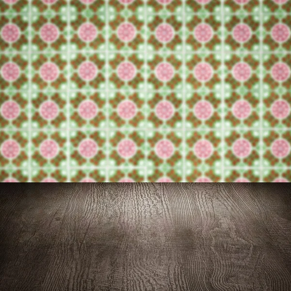 Wood table top and blur vintage ceramic tile pattern wall — Stock Photo, Image