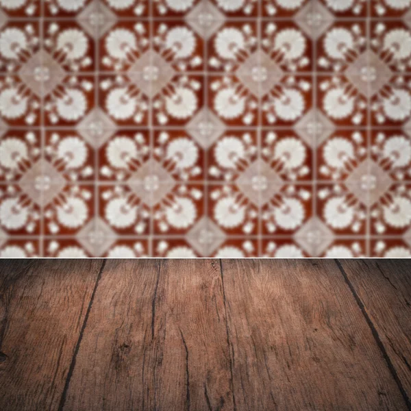 Wood table top and blur vintage ceramic tile pattern wall — Stock Photo, Image