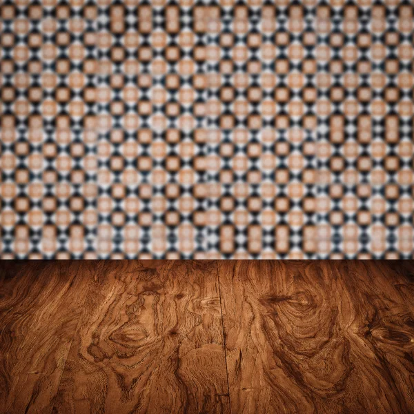 Wood table top and blur vintage ceramic tile pattern wall — Stock Photo, Image