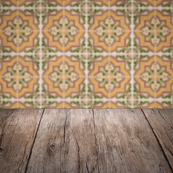 Wood table top and blur vintage ceramic tile pattern wall — Stock Photo, Image